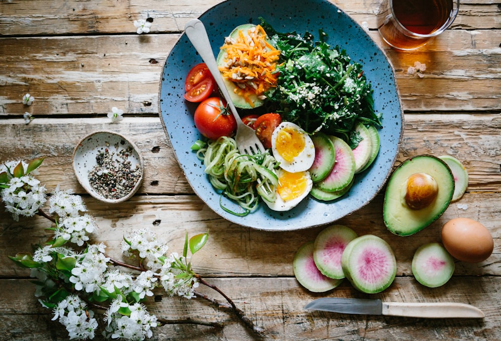 Poached egg with vegetables and tomatoes on a plate showing balanced portions