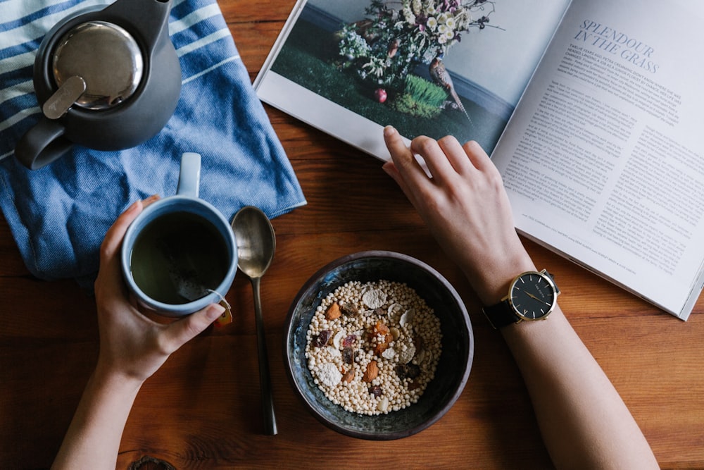 Person enjoying a relaxing morning coffee and reading as part of a healthy routine