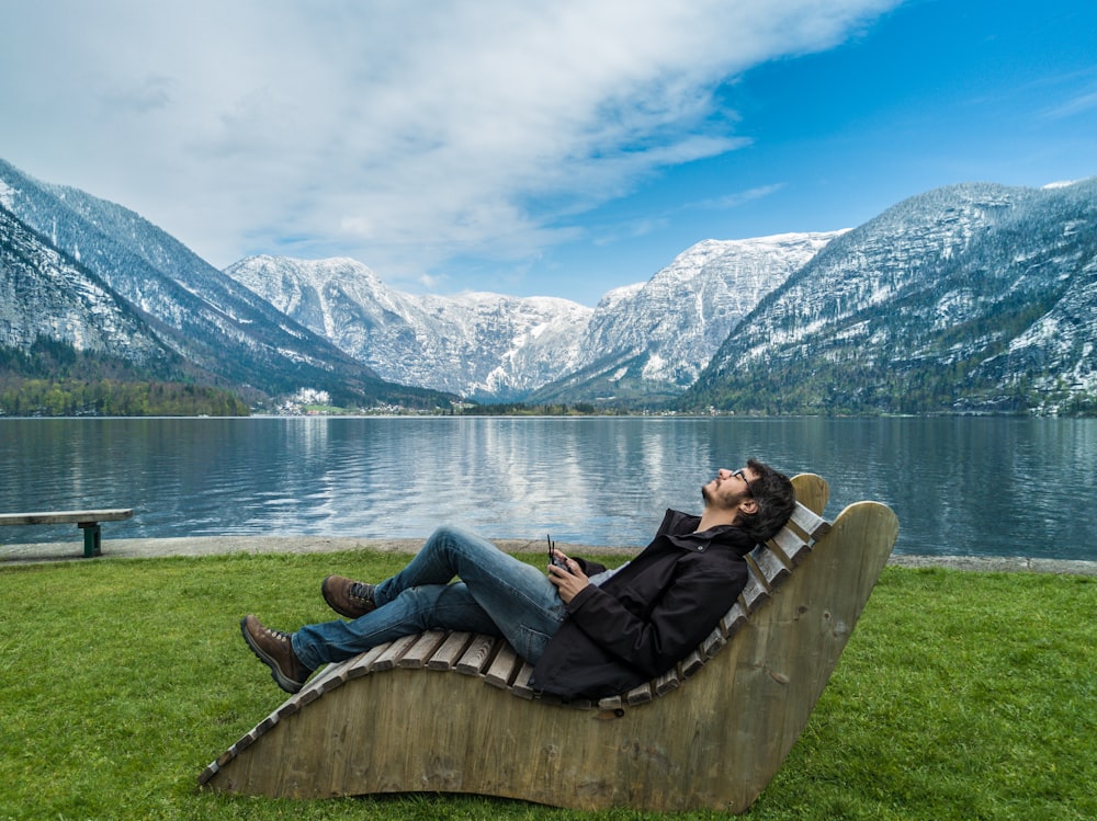 Man sitting calmly on a wooden chair overlooking nature