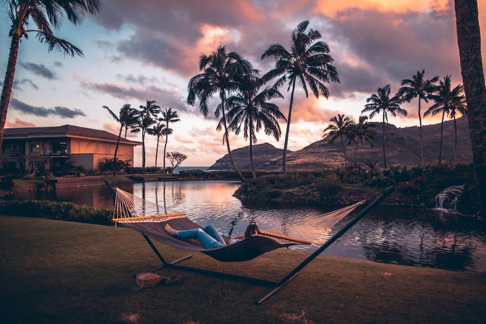 Person relaxing on a hammock over water as a stress relief technique